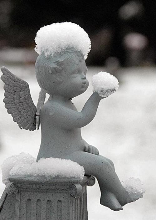 Cherub statue in snow